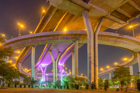Night scenic of light up on the highway bridge across the riverの写真素材