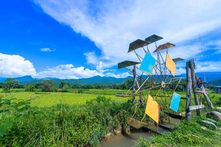 Beautiful mountain with meadow and forest as it is layer with the light shade at noon and can see the view by sitting at the chair which locates in Sapun village, Nan, Thailandの写真素材