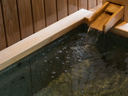Wooden faucet of Japanese style bathtubの写真素材