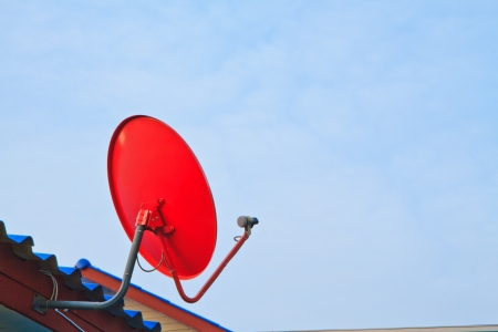 Satellite dish with sky on roofの写真素材