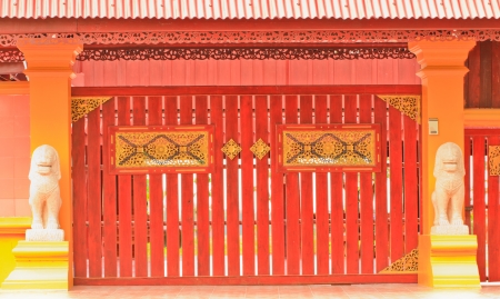 close-up image of red door and lion statueのeditorial素材