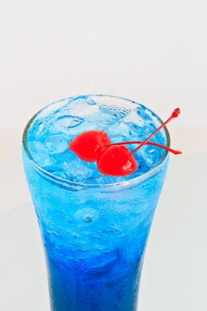 Close up one blue cocktail and cherry in glassの写真素材