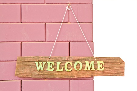 Welcome sign isolated on white and brick wall backgroundの写真素材