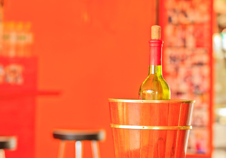 Bottle of wine in an wooden ice bucketの写真素材