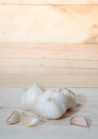 Fresh garlic isolated on wooden background.の写真素材