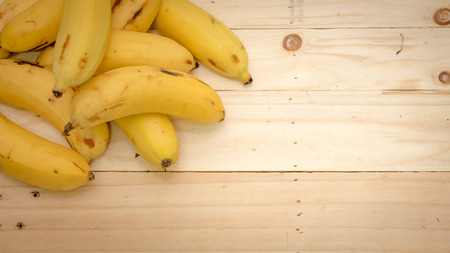 Bananas on  wooden board, top viewの写真素材