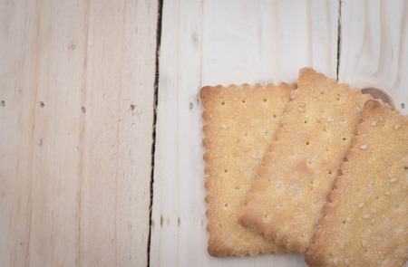 crackers isolated on wooden tableの写真素材