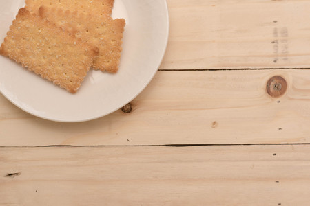 Delicious Whole grain crackers on wooden table.