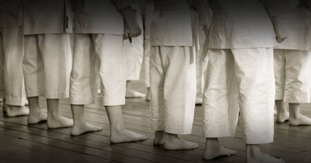 Kid's training on karate-do. Children in kimano before the exam. Photo without faces, from the back.の写真素材