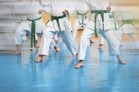 Martial arts art. Colored background with elements of movement and blur on the topic of children in karate. Without faces. For web design and printing.の写真素材