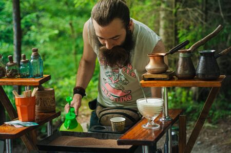 Karpaty, Ukraine, Shipot waterfall - July 20, 2019. A colorful Ukrainian man with a beard is making...