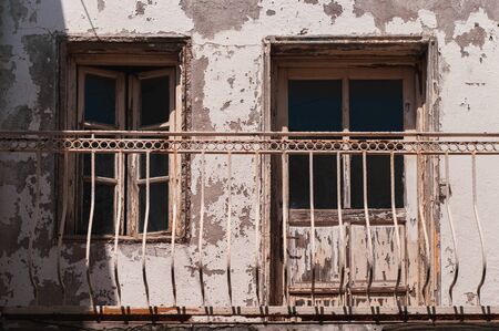 Facade of an old building with wooden windows and a balcony. The streets of the resort town of Turkey Bodrum.の写真素材