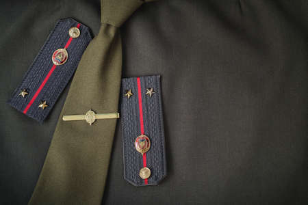Uniform, shoulder straps, tie and material, of the Ministry of Internal Affairs of the Republic of Belarus. Khaki color background image with place for text.の写真素材