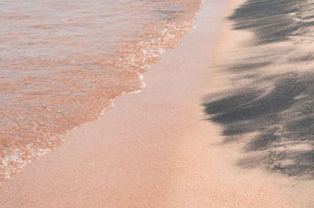 Transparent sea waves on the warm sandy seashore. Sea vacation and travel.の写真素材