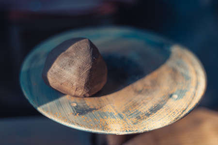 A piece of raw clay on the potter's wheel. Pottery. Traditional craft.の写真素材