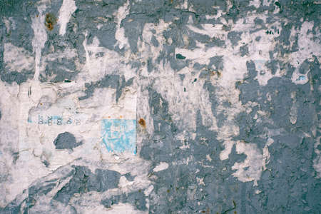 City billboard with torn posters. Streetboard for advertisements and announcements. Advertising...
