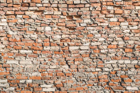 Old brick wall of light red color. Horizontal vintage background. Exterior.