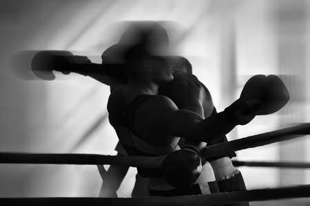 Black and white silhouettes of boxing athletes in the ring. Fighters in the clinch. Combat sports.の写真素材