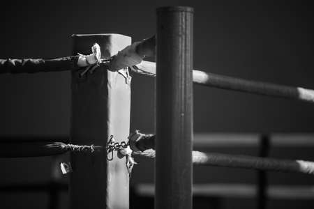 The corner of the boxing ring is large. The image has a shallow depth of field with focus at the point where the ropes are attached to the rack.の写真素材