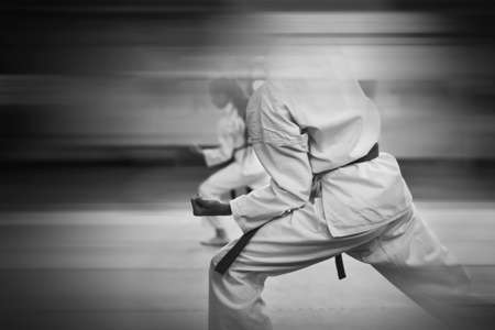 Karate-do training and a healthy lifestyle. Added blur effect for more motion effect. Retro style with imitation film grain. black and white.の写真素材