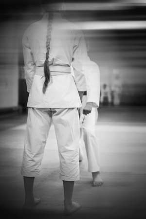 Karate-do training and a healthy lifestyle. Added blur effect for more motion effect. Retro style with imitation film grain. black and white.の写真素材