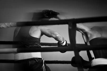 Set of sports black white background. Silhouettes of boxers in the ring. Restro style and photo film noise.の写真素材