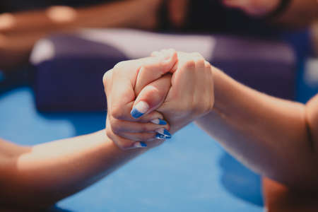 Amateur competitions in arm wrestling. The girls' hands are large.の写真素材