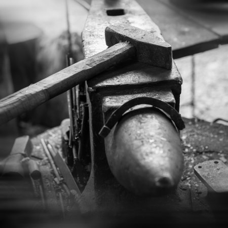 Ancient metal anvil with a hammer. black and white. blacksmithing and metalworking.の写真素材