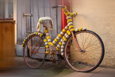 Retro bicycle with a frame and a saddle decorated with fur near the wall.の写真素材
