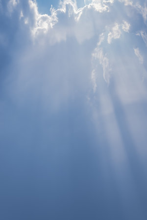 Sky with rays of sunlight through the clouds.