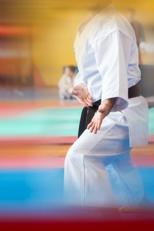 Colorful abstract background with a silhouette of a karateka in a white kimano performing kata. The concept of expression and motion blur.の写真素材