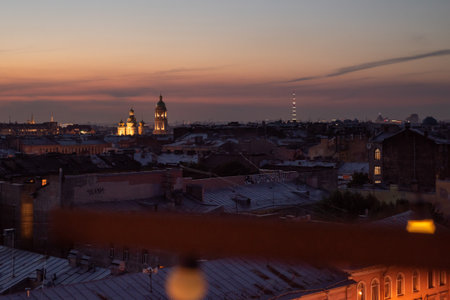Sunset over the city of St. Petersburg. View of the roofs of houses and the church against the backdrop of a beautiful sky.の写真素材