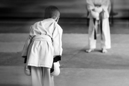 Young athletes in a white kimono bow before the fight. The concept of respect and character.の写真素材