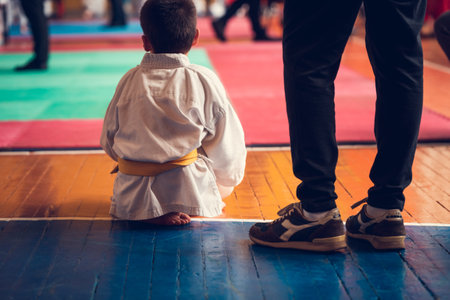 Karate kid in kimono trainingal arts school.の写真素材