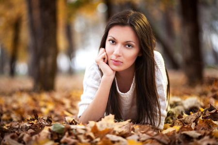 Beautyful young woman enjoying in the park at autumnの写真素材