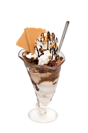 Ice cream cup with cream, topping and cookies isolatedの写真素材