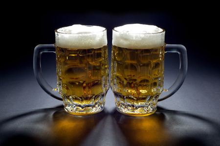 Pair of Cold Beer Mugs Waiting for Someone to Drink Themの写真素材