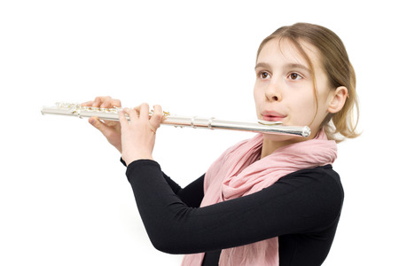 Young Talented Girl Practicing Flute Indoors. Half Length Studio Shot Isolated on Whiteの写真素材