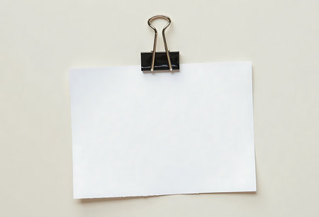 Blank paper with clip isolated on white background. Top view.の写真素材