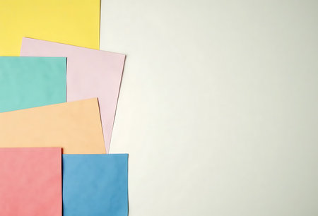 Colorful paper sheets on white background. Copy space for text.