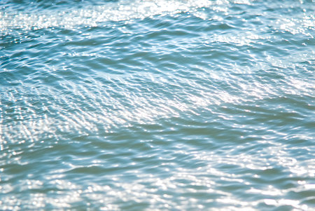 abstract background of sea water surface with waves and sunlight reflection.
