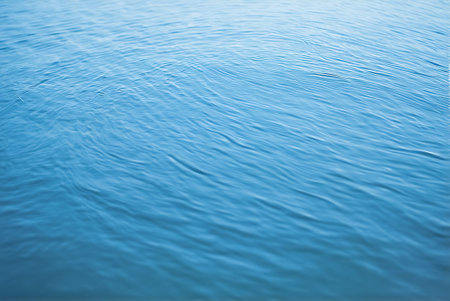 Water surface background with ripples and waves. Blue water surface.の写真素材