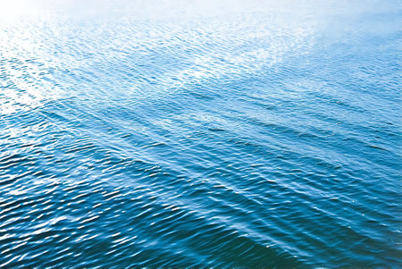 Blue water surface with ripples. Abstract background and texture for design.の写真素材
