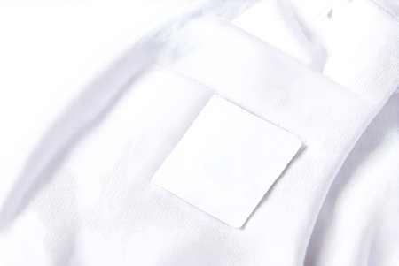 Blank business card on white shirt background. Mockup for branding identity.
