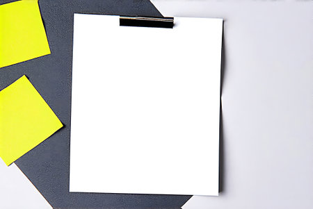 Blank paper sheet and sticky note on gray background. Copy space