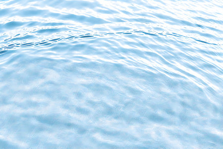 Blue water rippled texture background. Close up of water surface