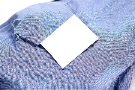 close up of a business card on a blue shirt, shallow depth of field