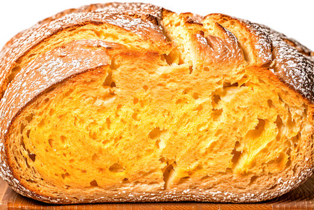 loaf of bread on a wooden board on a white background.