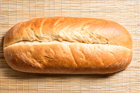 Loaf of bread on a bamboo napkin. Toned.