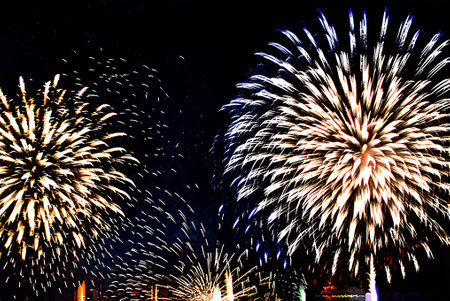 Colorful fireworks of various colors over night sky, celebrating new year and Christmasの写真素材